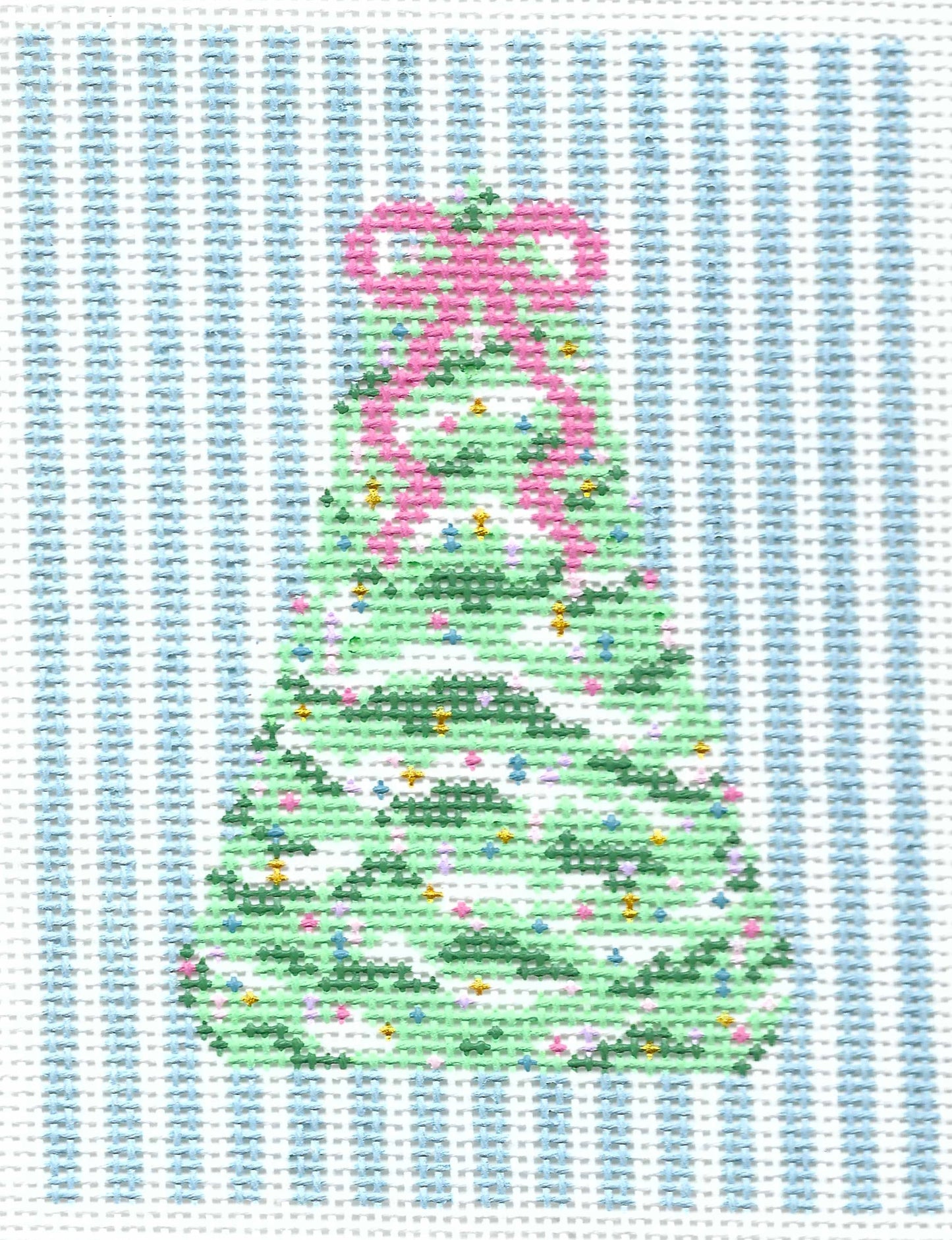 SLS Needlepoint canvas of a green Christmas tree with a pink bow and small colorful ornaments on a background of vertical light blue and white stripes.