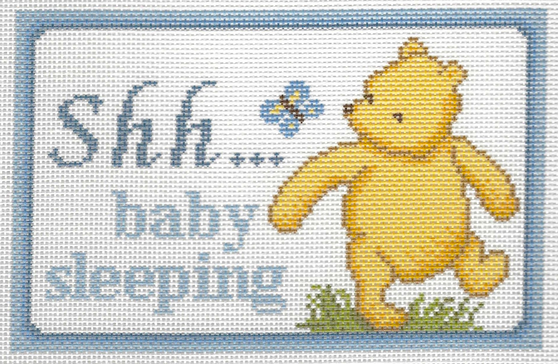 Needlepaint needlepoint canvas of Pooh and a butterfly with 'Shh... baby sleeping' text on a white background with light blue border