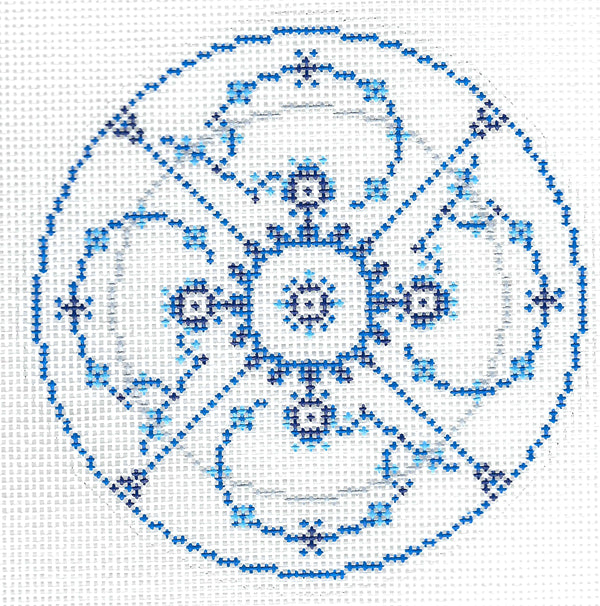 C'ate La Vie round needlepoint canvas with blue and silver symmetrical floral and scroll design on a white background.