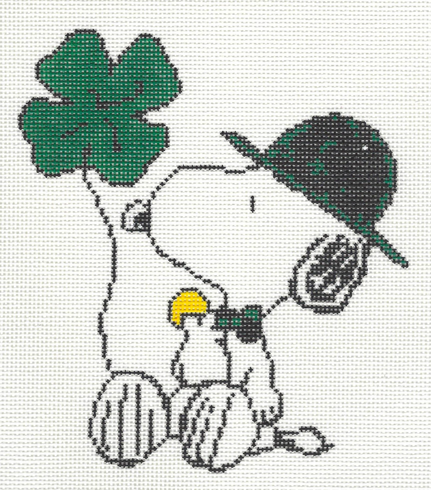 Officially Needlepoint canvas of Snoopy wearing a black and green hat holding shamrock balloon