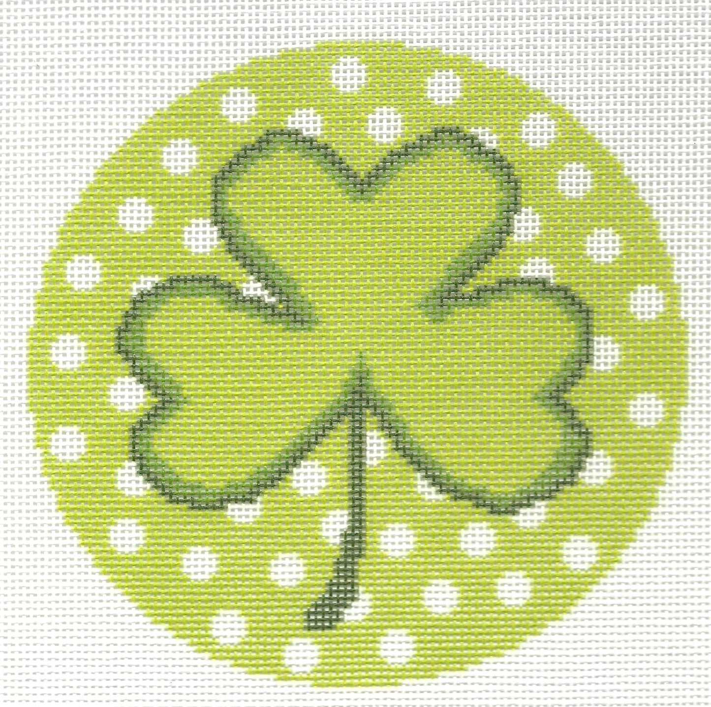 Needlepaint round needlepoint canvas of green four-leaf clover on a green background with white polka dots