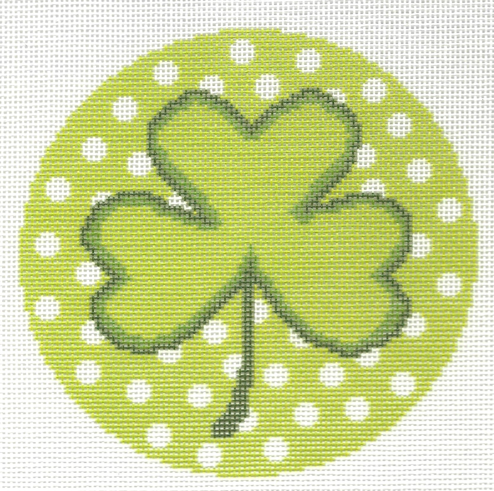 Needlepaint round needlepoint canvas of green four-leaf clover on a green background with white polka dots