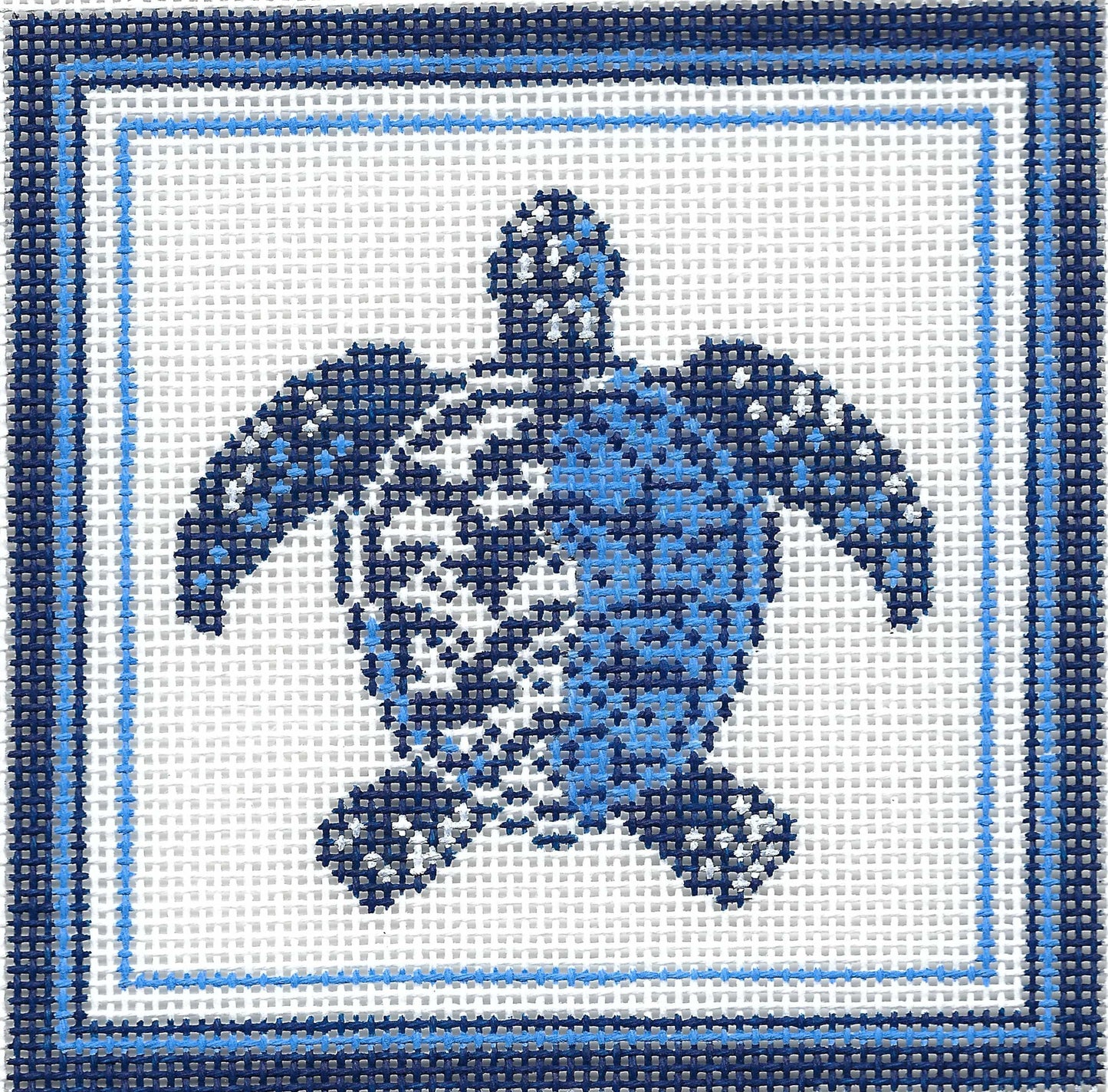 Kirk & Bradley square needlepoint canvas featuring a blue sea turtle design on a white background, framed by concentric light and dark blue borders.