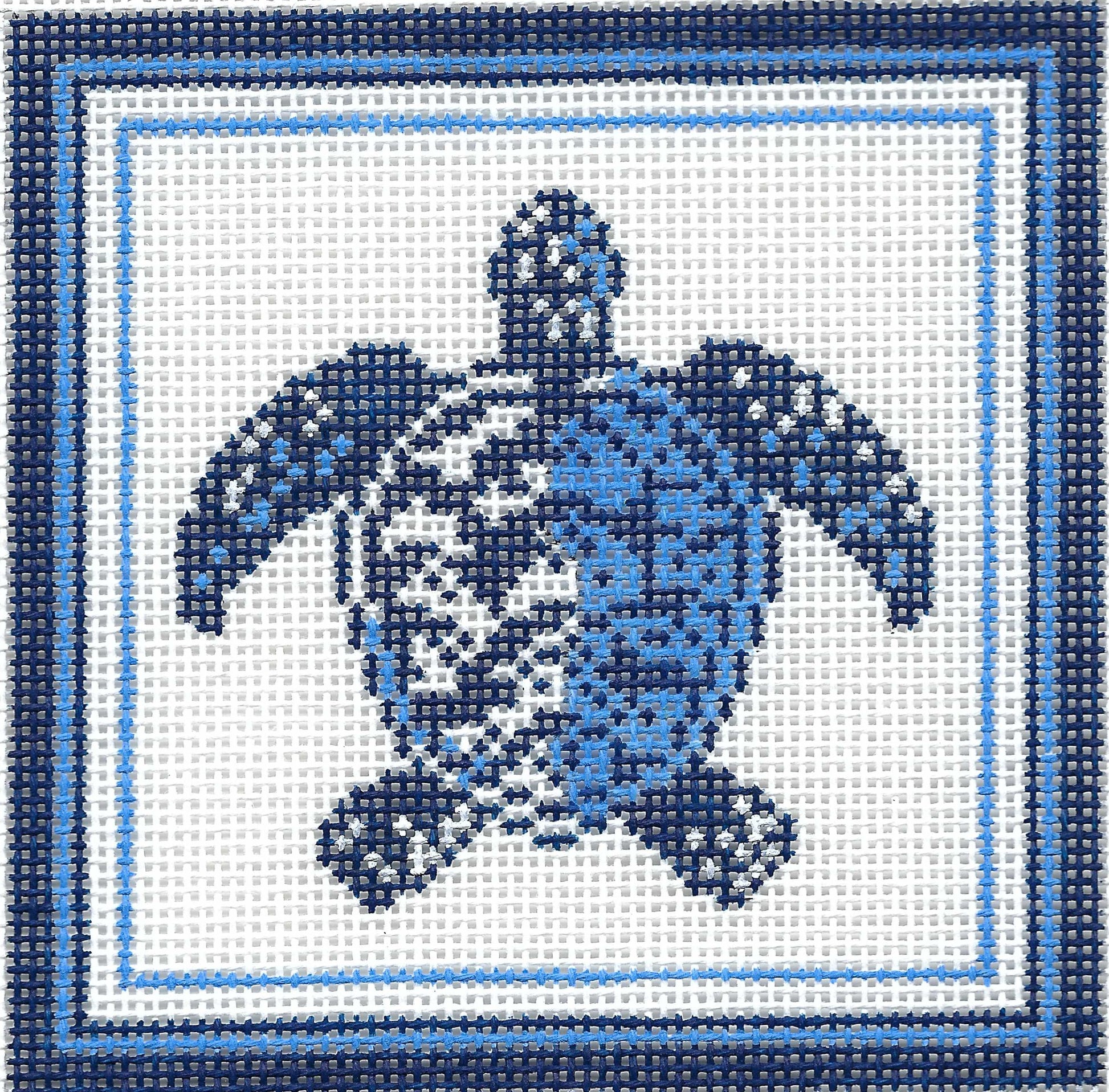 Kirk & Bradley square needlepoint canvas featuring a blue sea turtle design on a white background, framed by concentric light and dark blue borders.
