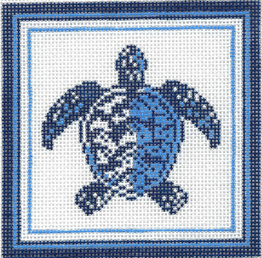 Kirk & Bradley square needlepoint canvas featuring a blue sea turtle design on a white background, framed by concentric light and dark blue borders.