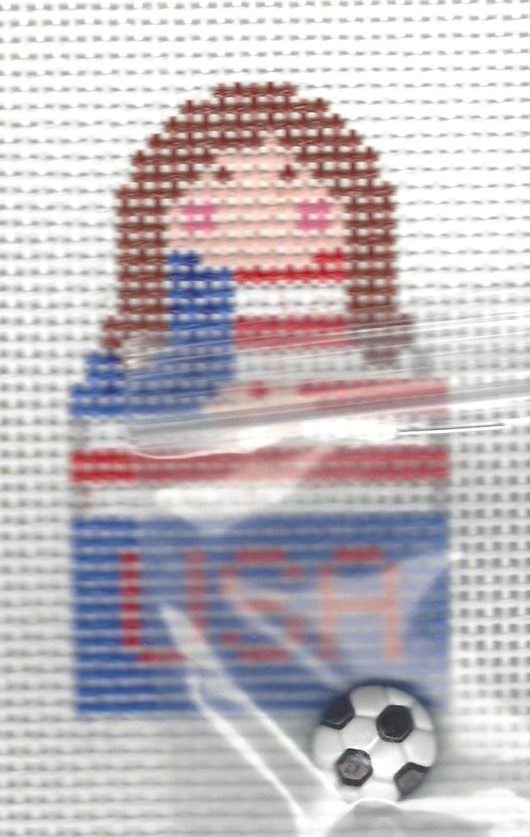 KCN Designers needlepoint canvas of a Georgette's Angel in American flag with text 'USA' and a soccerball.