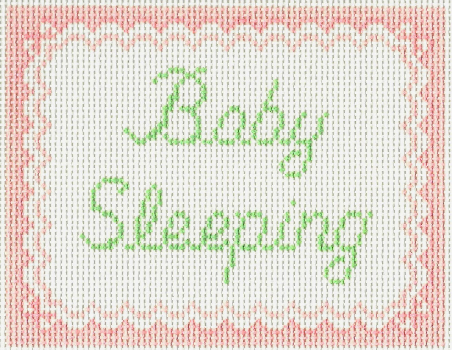 SLS Needlepoint canvas of 'Baby Sleeping' text with a pink border.