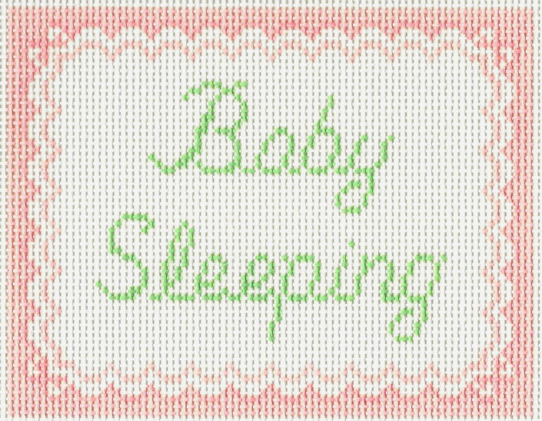 SLS Needlepoint canvas of 'Baby Sleeping' text with a pink border.
