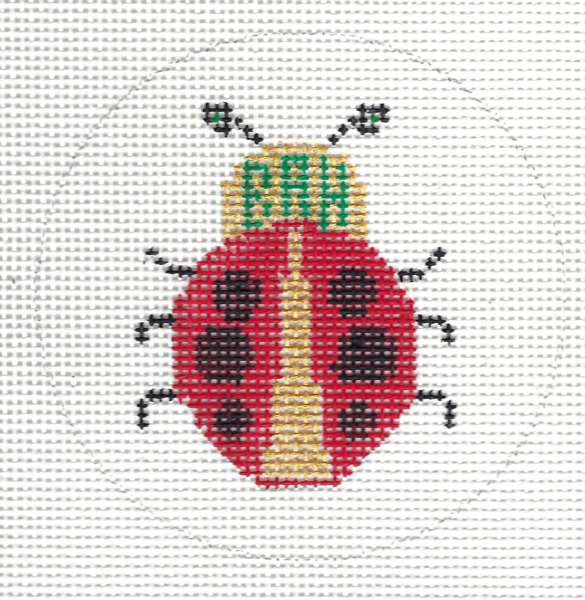 Patricia Stone round needlepoint canvas of a ladybug design with a red body, black spots and legs, a yellow belly, and green embroidered letters reading 'BAH' on the head.