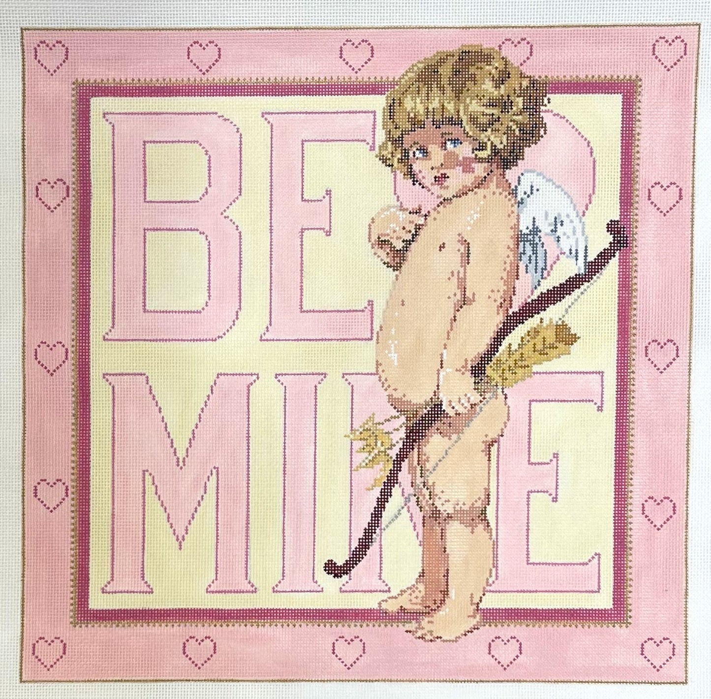 Sandra Gilmore needlepoint canvas of cupid holding bow and arrow with 'BE MINE' text on a pink background