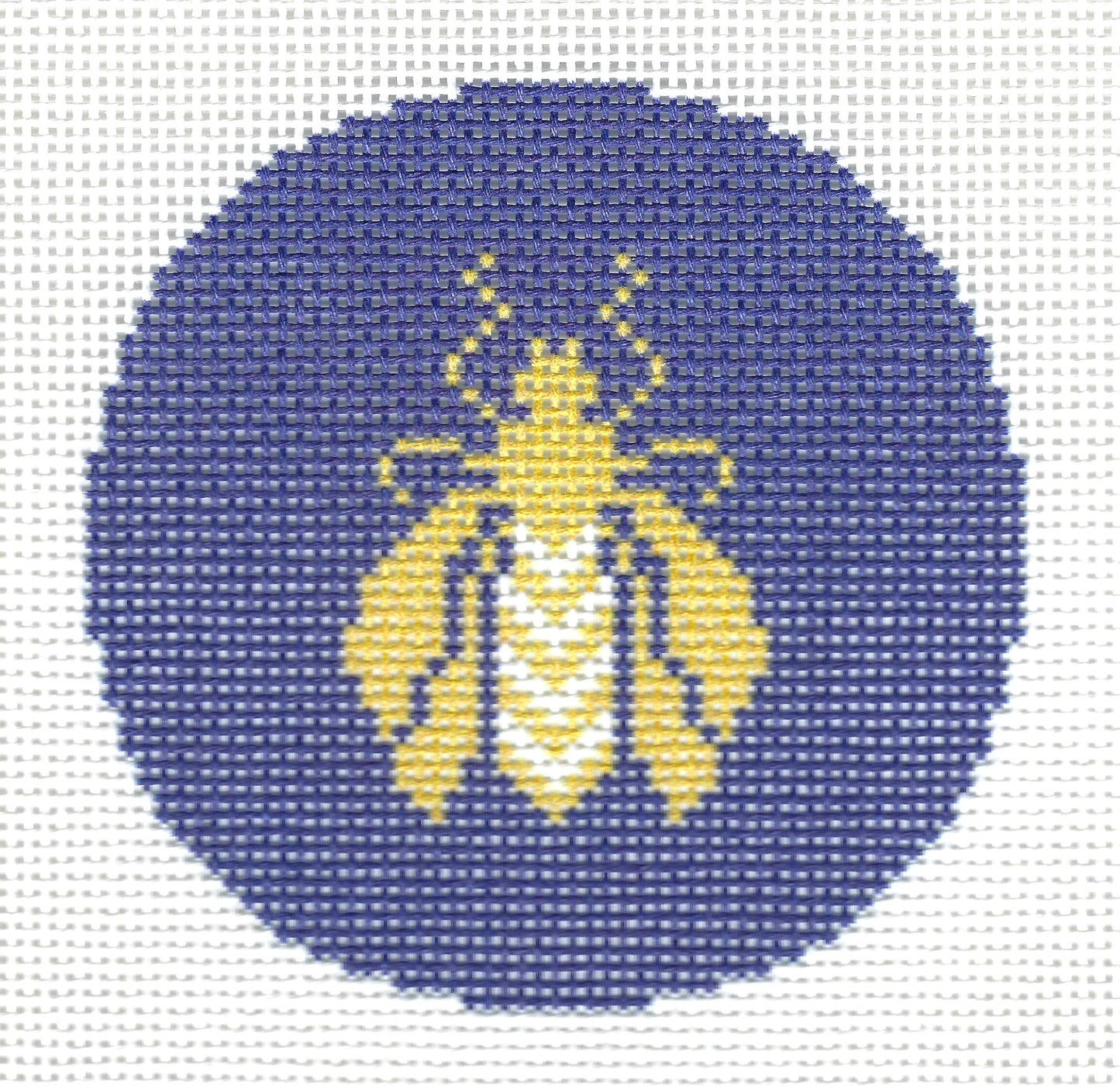 Needlepoint To Go circular needlepoint canvas featuring a stylized yellow and white bee on a dark blue background.