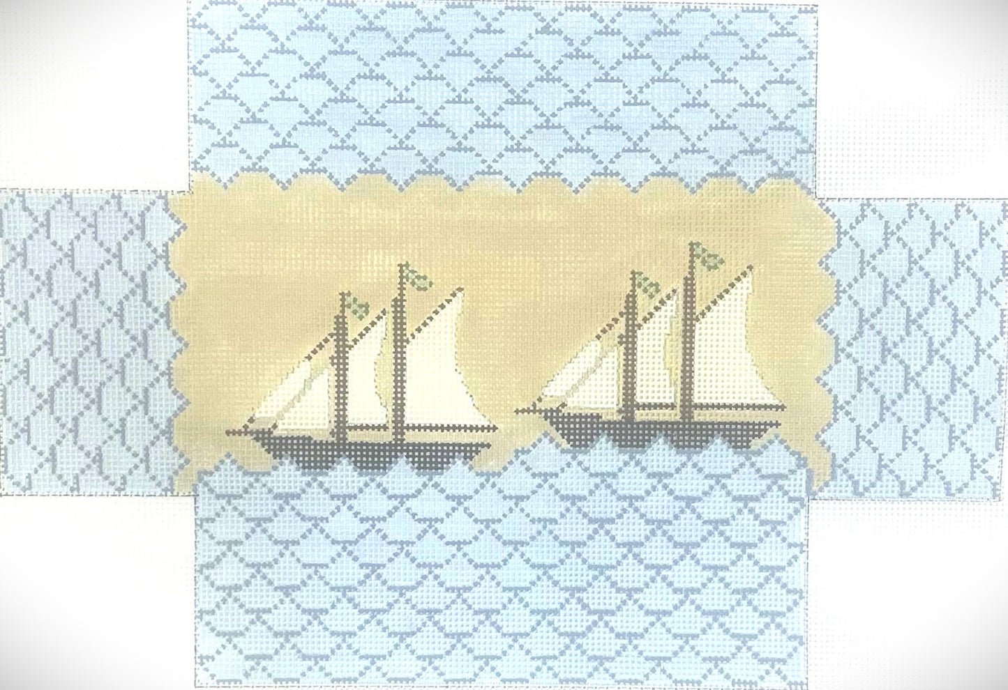 j. childs needlepoint canvas of brickcover with two sailboats and waves design.