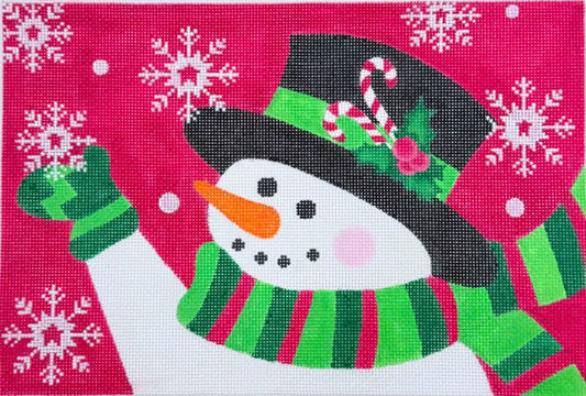 Pepperberry Designs needlepoint canvas featuring a snowman wearing a black top hat decorated with a candy cane, holly leaves, and a pink rose, along with a green and red striped scarf and matching green mittens. The background is a vibrant pink adorned with white snowflakes.