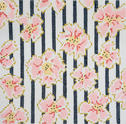 The Plum Stitchery needlepoint canvas of a floral pattern with coral and gold flowers and black vertical stripes on a white background.