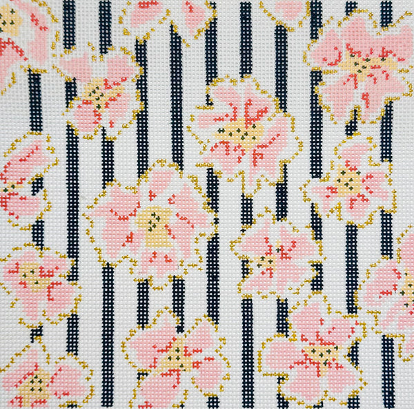The Plum Stitchery needlepoint canvas of a floral pattern with coral and gold flowers and black vertical stripes on a white background.