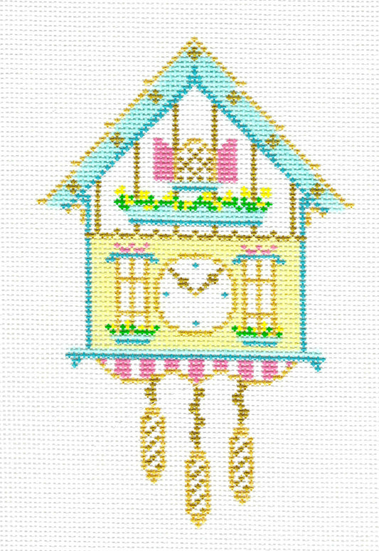 The Plum Stitchery needlepoint canvas of a traditional German cuckoo clock, featuring a light blue roof, pale yellow body, pink windows, and hanging gold weights on a white background.