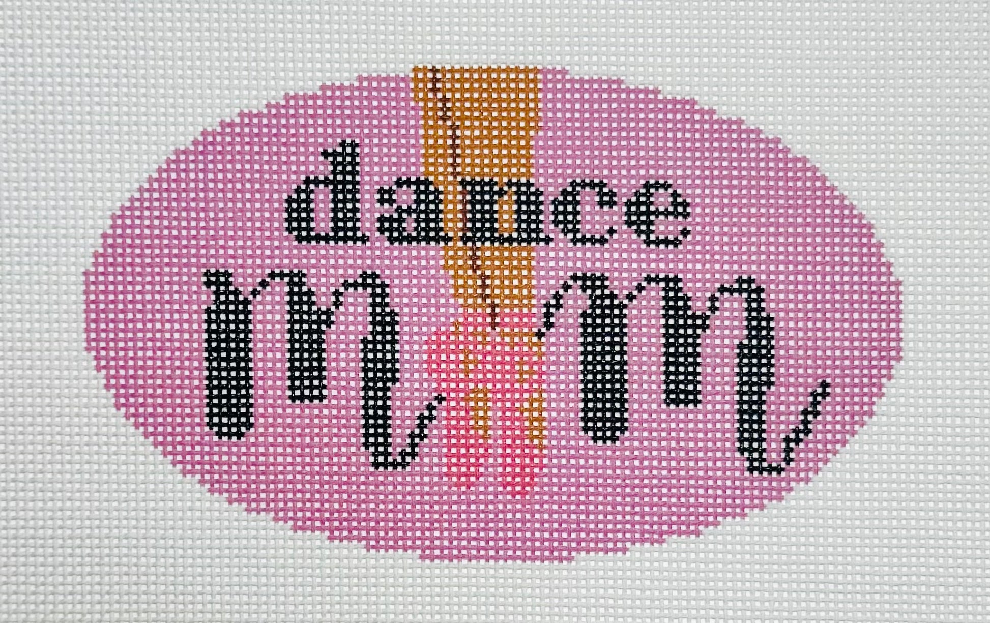 KCN Designers needlepoint canvas of 'Dance Mom' with ballet slippers for the 'O' in 'mom' on a pink background.