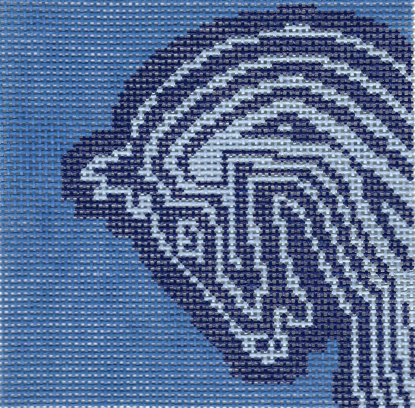 Maura Nolan needlepoint canvas of a decorative horse head in dark blue and light blue lines on a blue background.