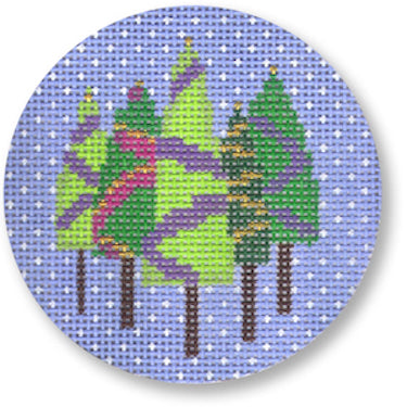Designs By Karen circular needlepoint canvas featuring stylized green pine trees with purple and pink accents on a light blue background with white snow-like speckles.