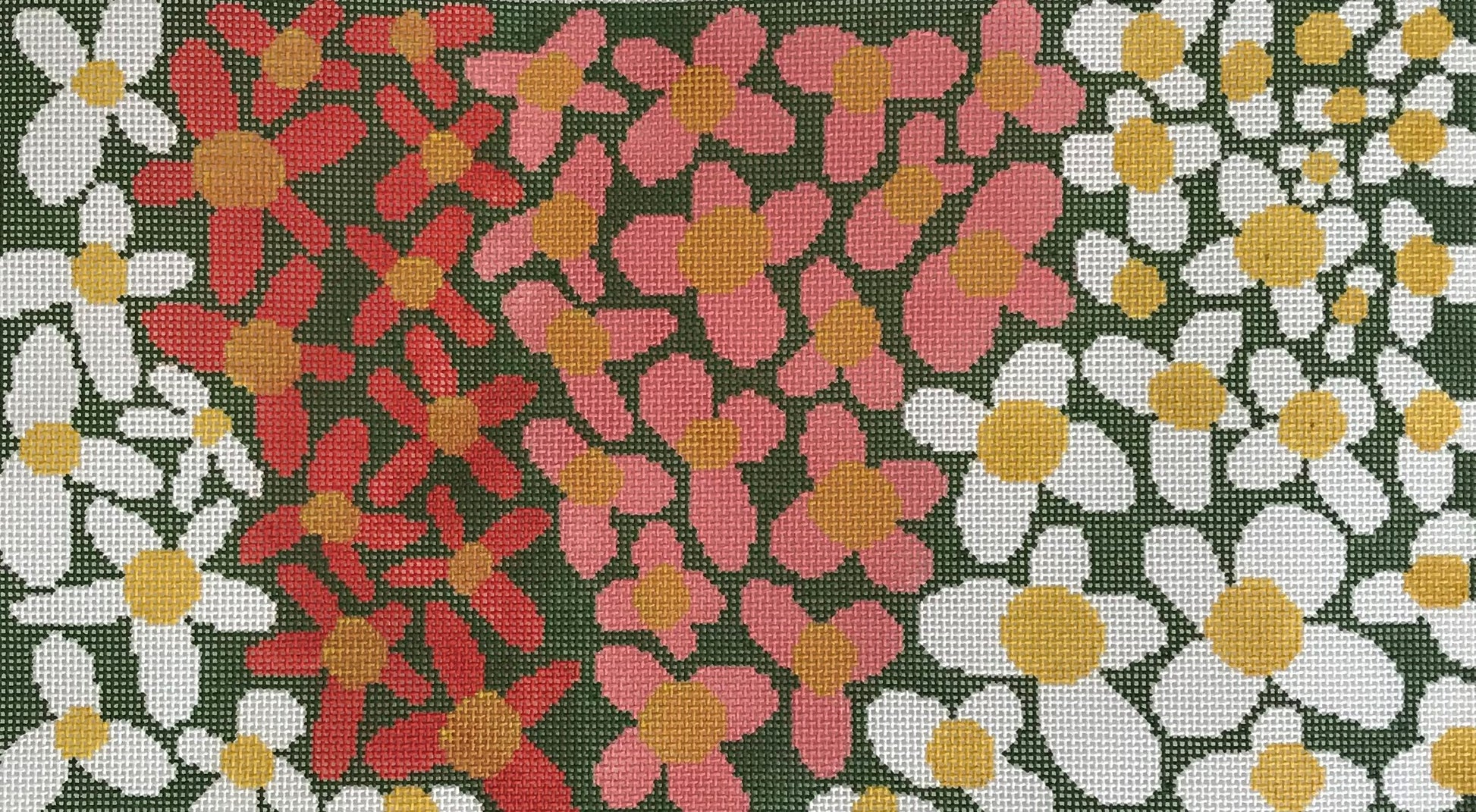 The Meredith Collection needlepoint canvas of a close-up of a floral bed featuring large pink. red, and white flowers with yellow centers on a dark green background.