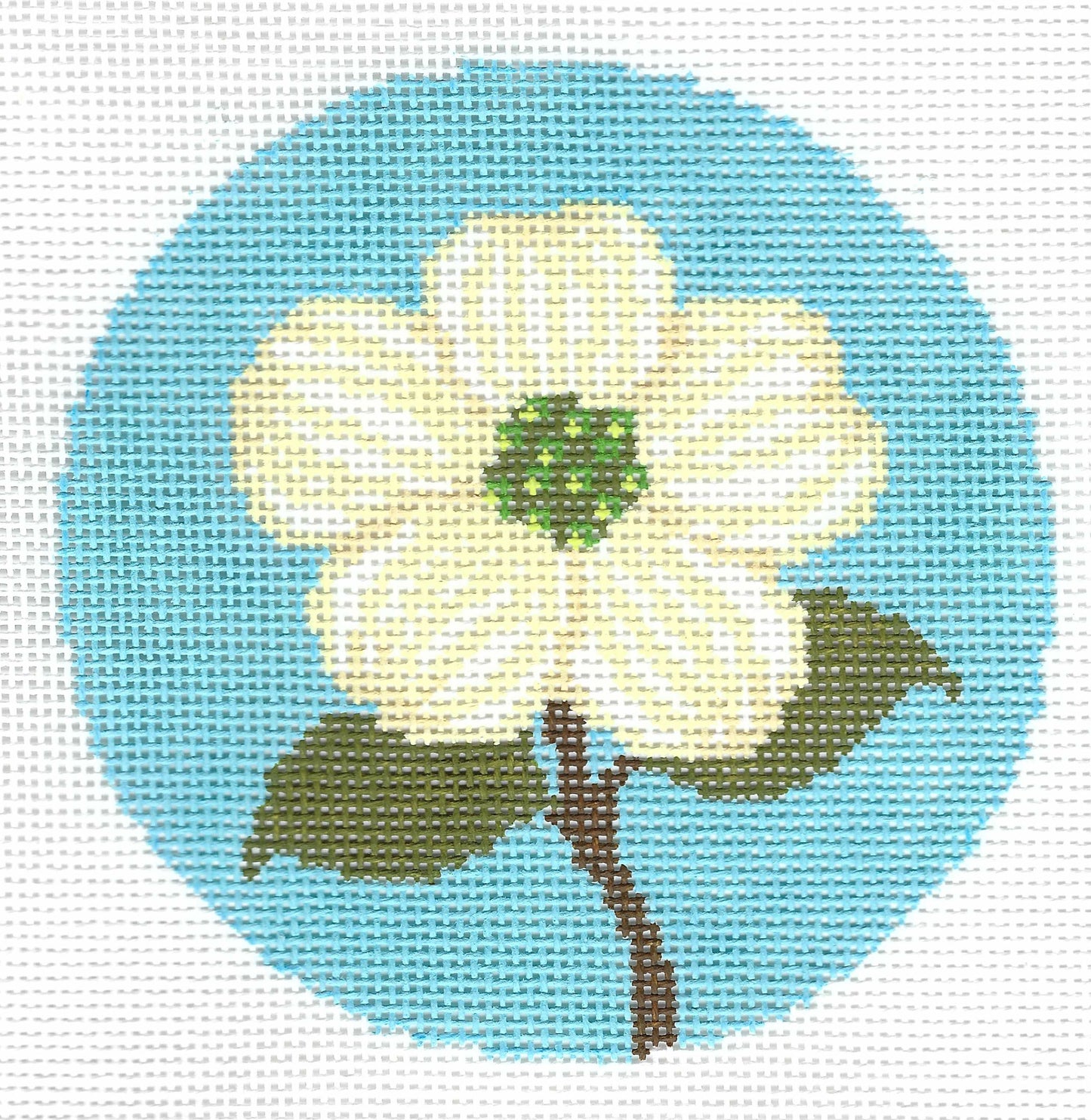 Circular needlepoint canvas featuring a white dogwood flower with a green center, brown stem, and green leaves, set against a light blue circle.