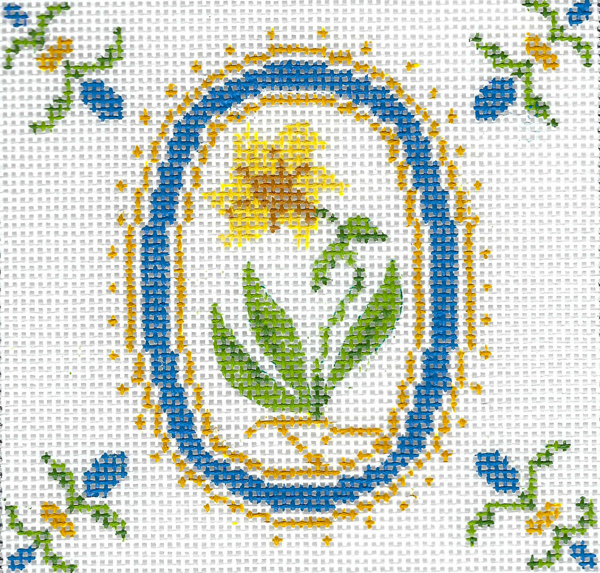 Tina Griffins Designs needlepoint canvas of a decorative pattern with flowers and leaves on a white background.