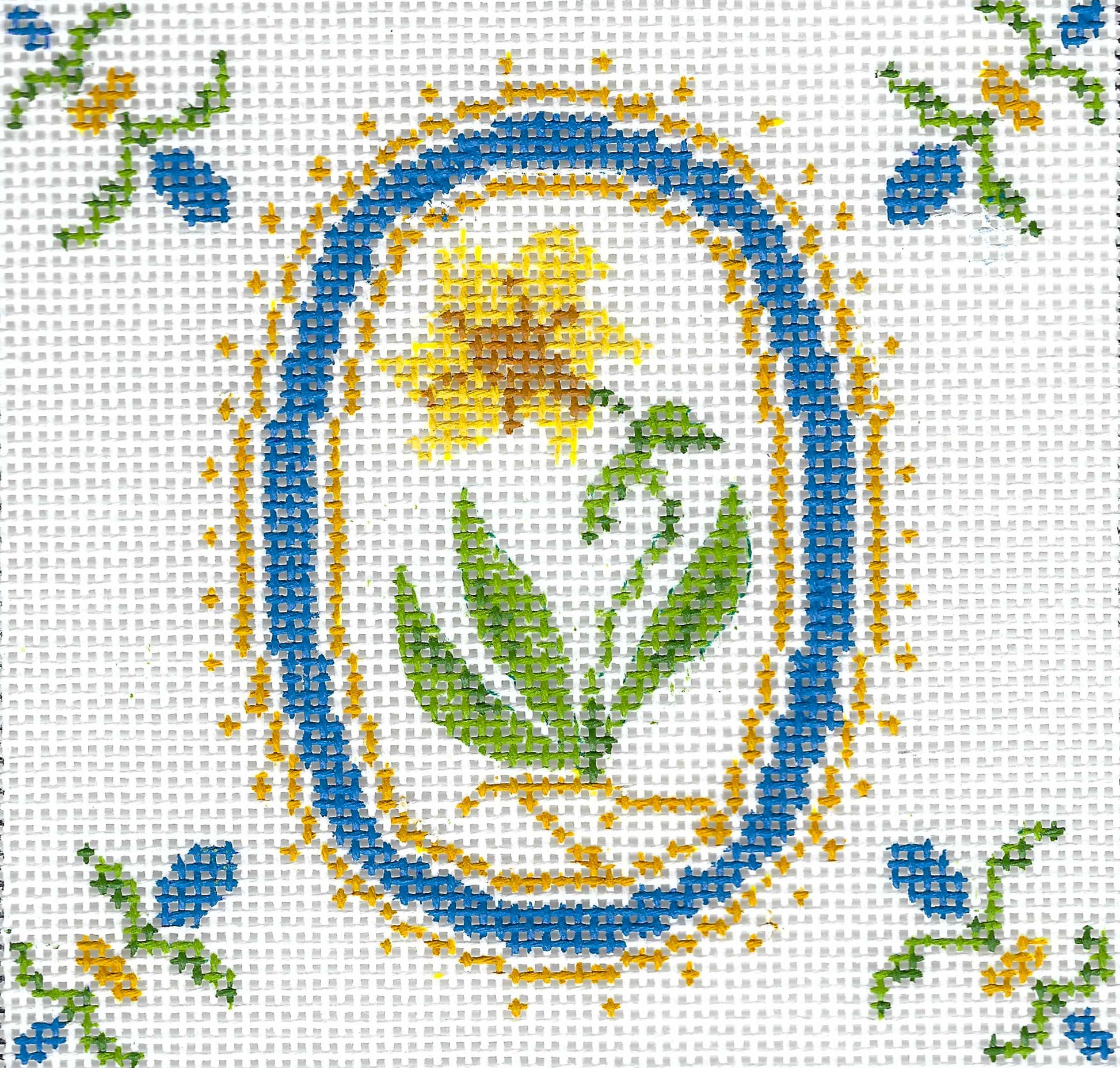 Tina Griffins Designs needlepoint canvas of a decorative pattern with flowers and leaves on a white background.