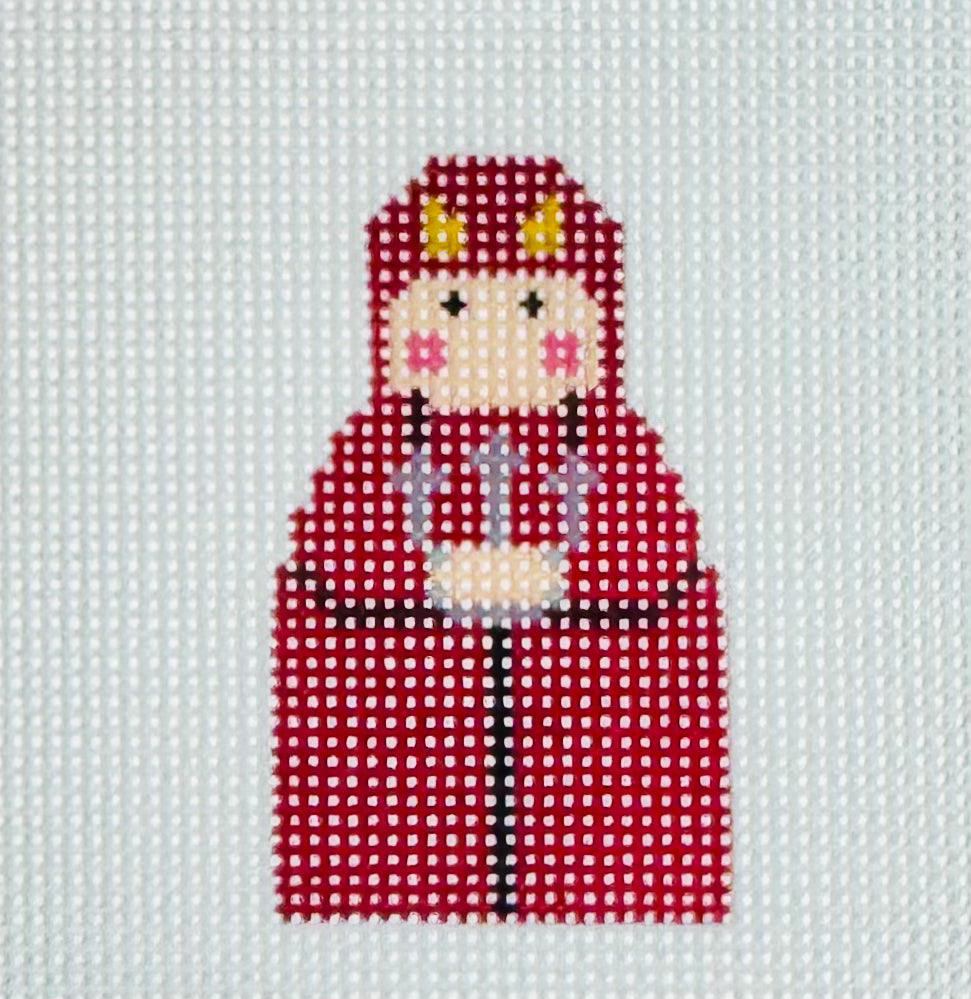 KCN Designers needlepoint canvas of a Georgette's Angel of Devil with a long red cape, yellow horns, and a pitchfork