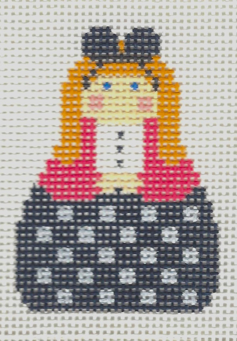 KCN Designers needlepoint canvas of a Georgette's Angel with mouse ears, wearing a pink sweater and a black and white checkered skirt.