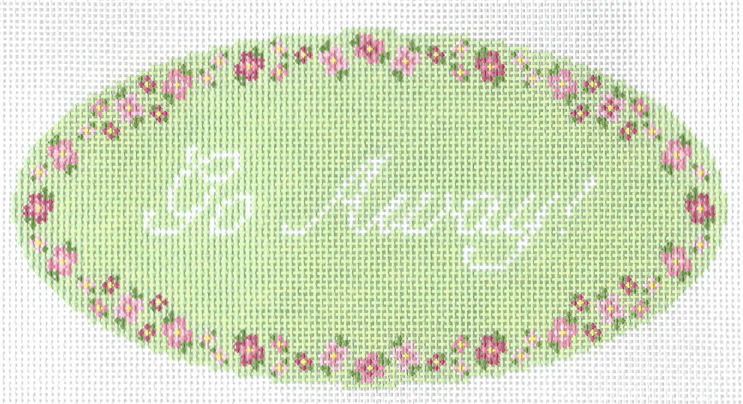 Maura Nolan needlepoint canvas of text 'Go Away!' on a green oval background with a floral border.
