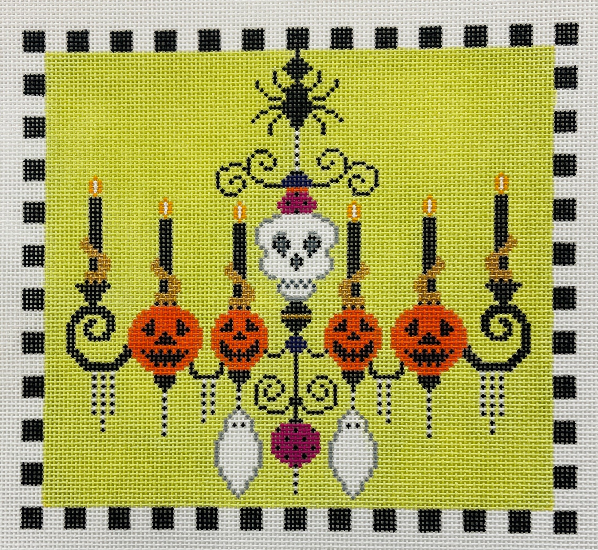 Shelly Tribbey needlepoint canvas of Halloween-themed chandelier with candles, jack-o'-lanterns, and a skeleton on a green background.