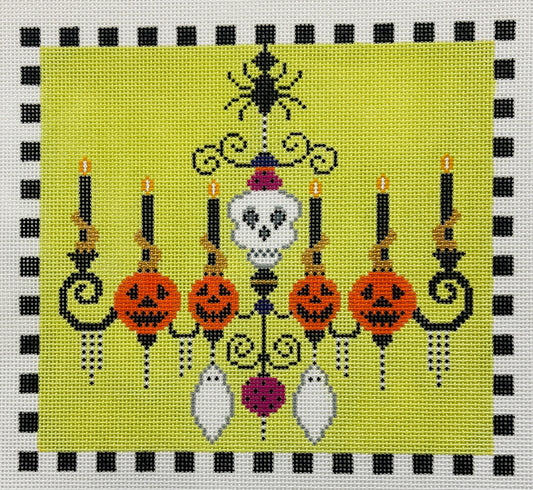 Shelly Tribbey needlepoint canvas of Halloween-themed chandelier with candles, jack-o'-lanterns, and a skeleton on a green background.