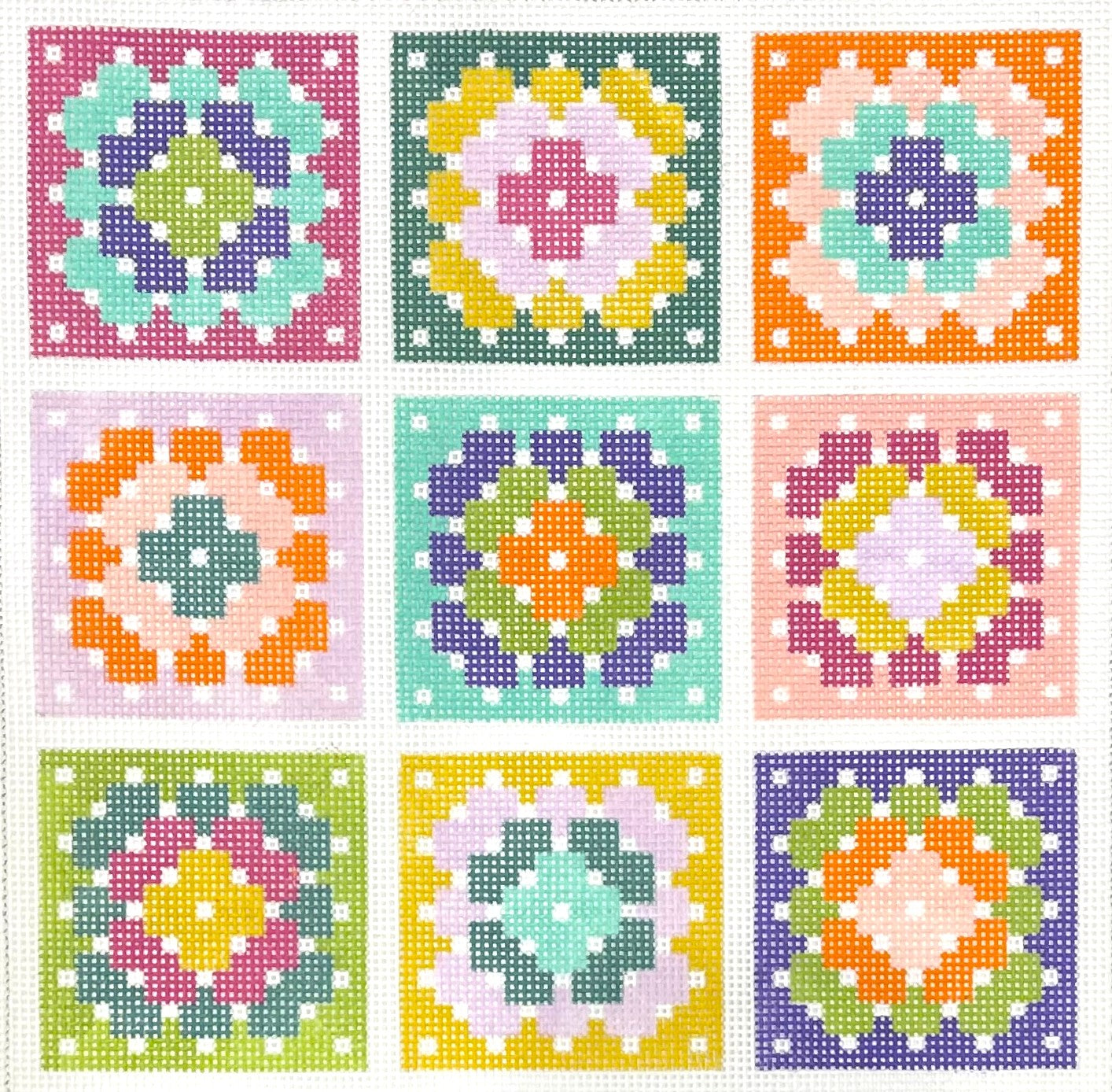 Stitch Rock needlepoint canvas of a grid of colorful geometric patterns on a white background