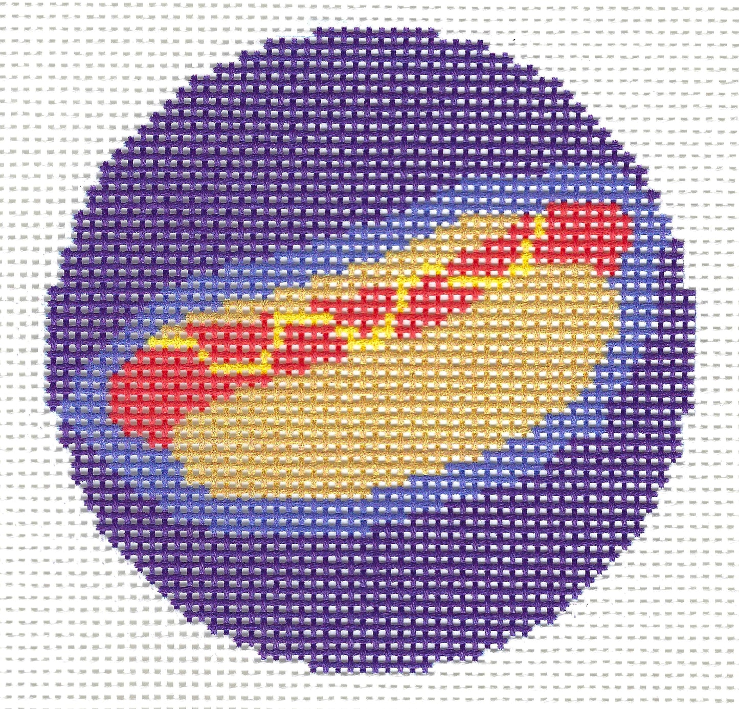 Threaded & Tipsy circular needlepoint canvas design featuring a red hot dog illustration with a light brown bun, and yellow toppings set against a purple and blue background.