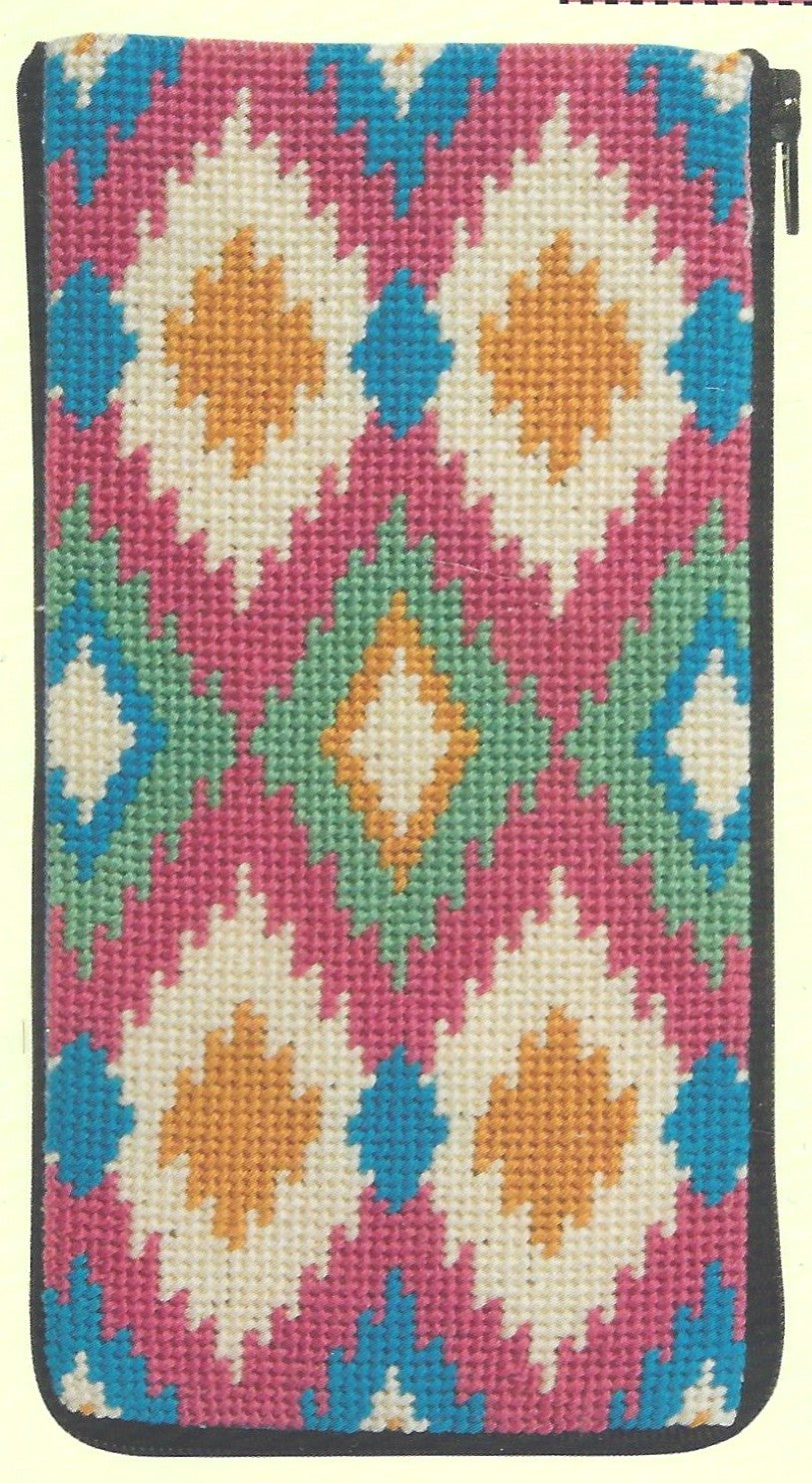 Stitch & Zip eyeglass case needlepoint canvas of ikat-pattern on a pink background.
