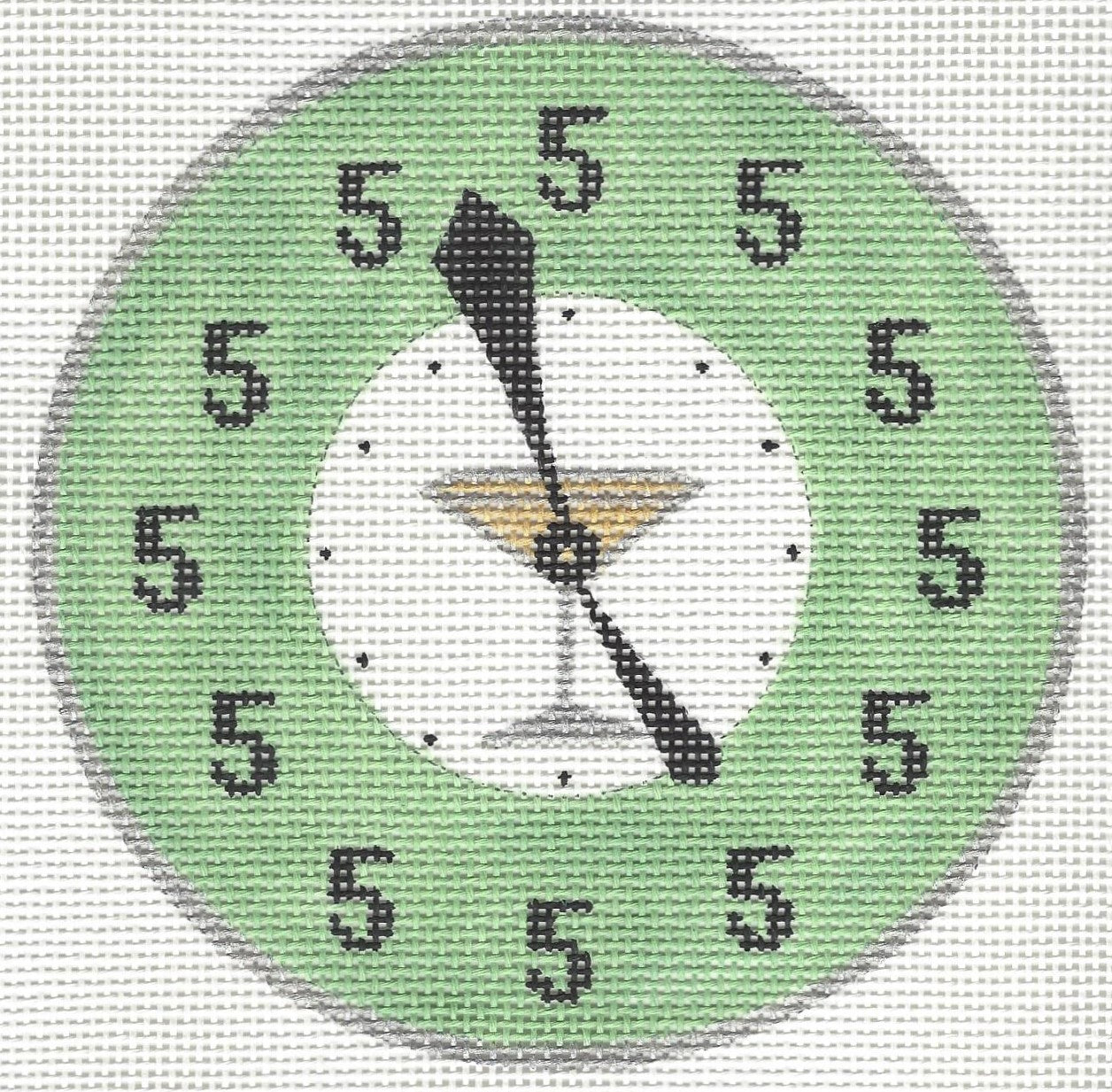 Patricia Stone circular needlepoint canvas of a clock face design with a light green outer ring, black numerals, and a martini glass illustration in the center.