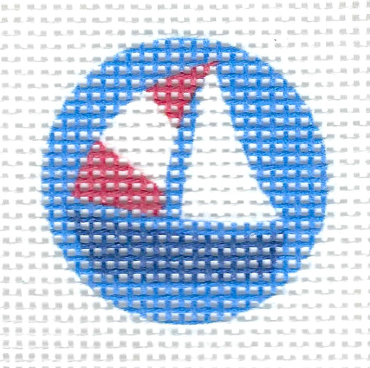 Tilli Tomas Planet Earth circular needlepoint canvas of a sailboat in blue, white, and red, on a blue background.
