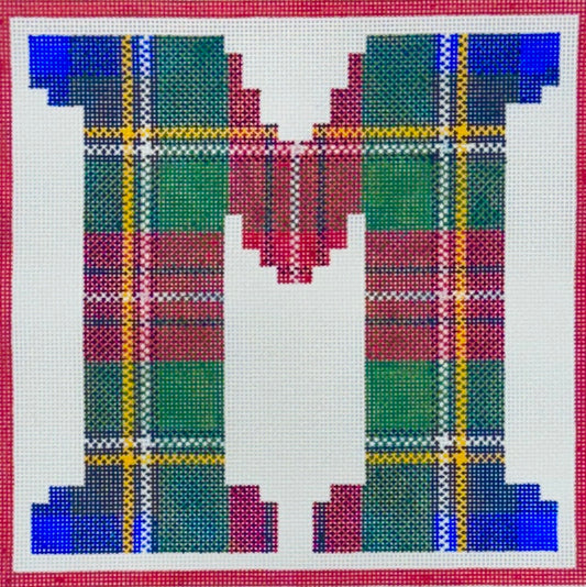 Treglown square needlepoint canvas featuring the letter 'M' filled with a tartan plaid pattern in green, red, blue, yellow, and white, bordered by a red grid.