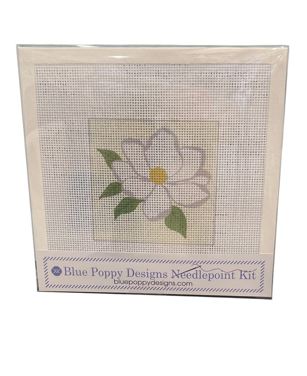 Blue Poppy Designs needlepoint kit with a white magnolia design on a white background