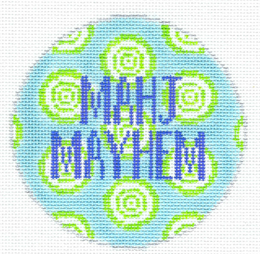 Melissa Loves Needlepoint circular needlepoint canvas featuring the text 'MAHJ MAYHEM' in blue block letters over a light blue background with lime green and white concentric spiral patterns.