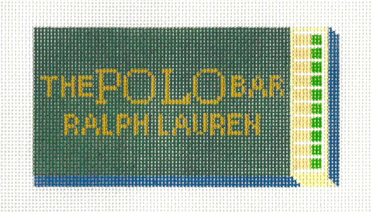 Spruce Street Studios needlepoint canvas of a dark green matchbox with gold text 'The Polo Bar Ralph Lauren' on a white background.
