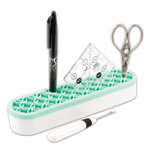 Yarn Tree mint green and white sewing kit with scissors, seam ripper, pen, and a ruler on a white background.