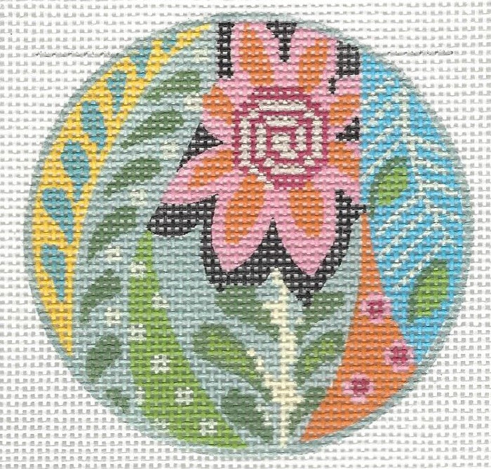 Kelly Clark round needlepoint canvas of mod Meredith with decorative design of flowers, leaves, and patterns