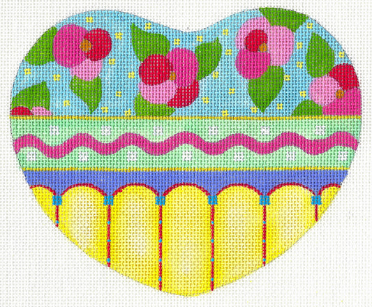 Jane Aurich heart-shaped needlepoint canvas featuring a colorful, patterned design with pink flowers on a light blue top section, a pink wavy stripe, a purple band, and yellow arches.