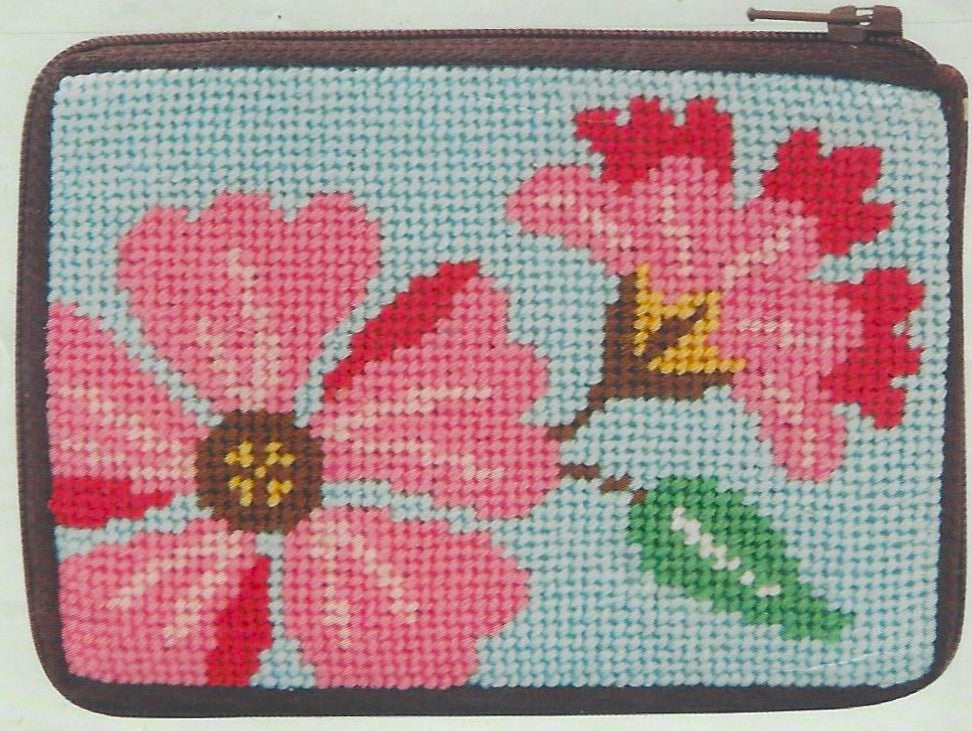 Stitch & Zip needlepoint kit of a coin purse with pink flowers design on a light blue background.