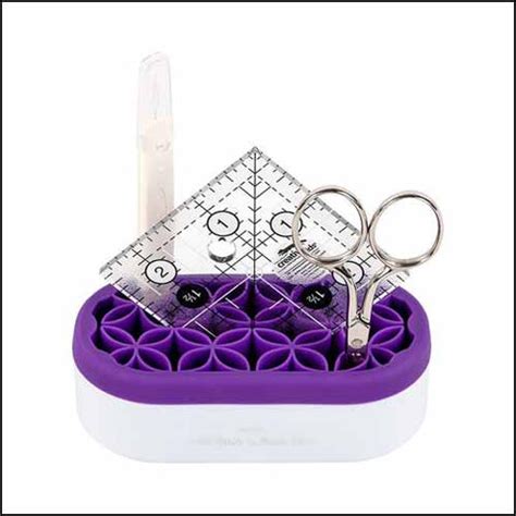 Yarn Tree purple and white sewing kit with scissors and a ruler on a white background.