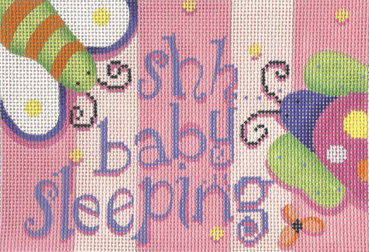Associated Talents needlepoint canvas of 'shh baby sleeping' text and cartoonish butterfly designs on a pink background.