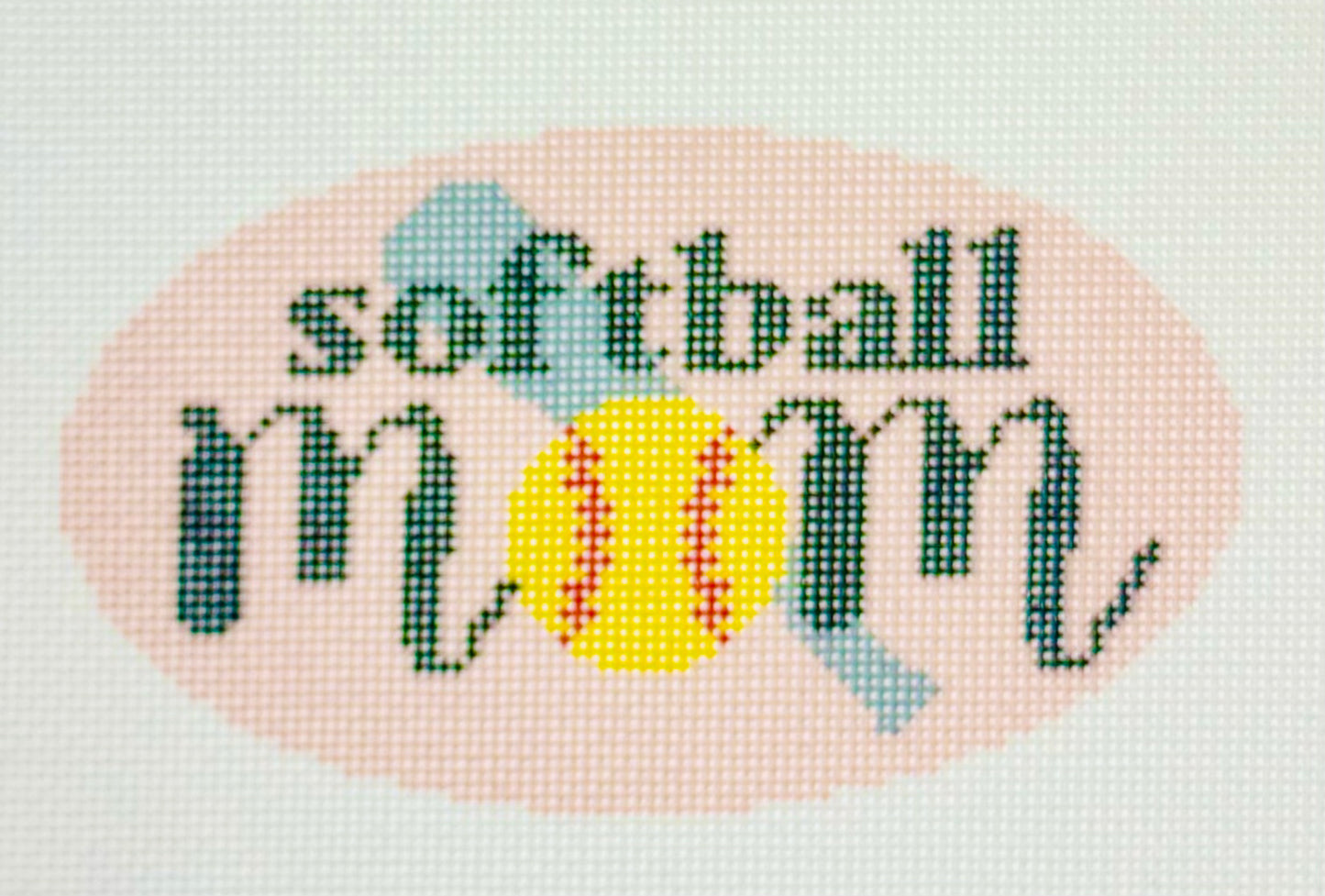 KCN Designers needlepoint canvas of 'Softball Mom' with a softball for the 'O' in 'mom' on a light pink background.