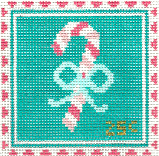 Stitch Rock needlepoint canvas of a candy cane with a red and white patterned border on a teal background.