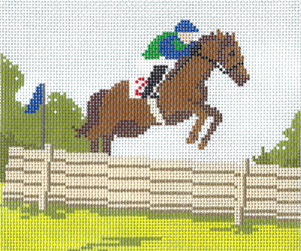 Ann Kaye needlepoint canvas of horse and jockey jumping over a fence with trees in the background